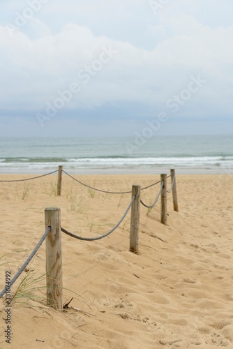 Rope fence on the beach in a cloudy day 