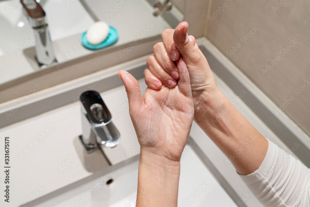 Woman following steps to wash properly with soap and sanitize and disinfect hands. Cleaning measures against propagation of viral covid 19 disease. Coronavirus, health and hygienic concept.