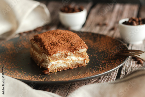 Tiramisu cake on a plate. Romantic composition with coffee and other elements