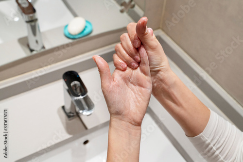 Woman following steps to wash properly with soap and sanitize and disinfect hands. Cleaning measures against propagation of viral covid 19 disease. Coronavirus, health and hygienic concept.