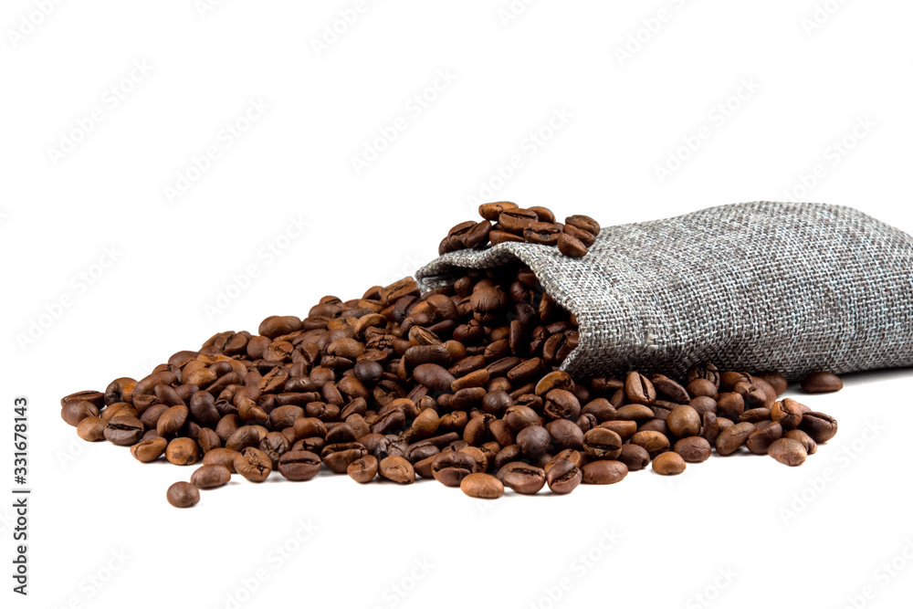 Roasted coffee beans spilling out from a burlap sack  isolated on a white background