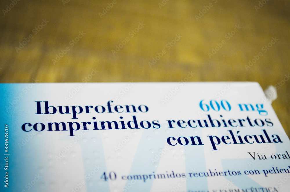 Selective focus on a box of Ibuprofen 600 mg on a wooden table with the text Selective focus on a box of Ibuprofen 600 mg on a wooden table with the text
