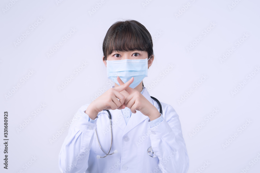 Young female doctor woman wearing mask, making stop sign gesture, saysignaling No isolated on white background, refusing virus disease, close up, blank. Young female doctor woman wearing mask, making stop sign gesture, saysignaling No isolated on white background, refusing virus disease, close up, blank.