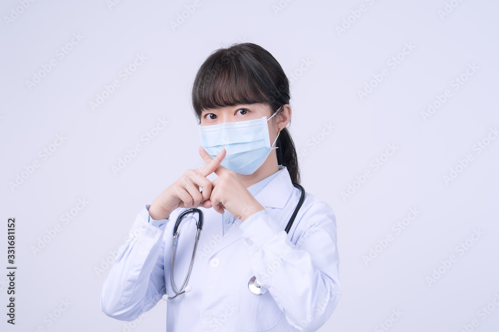 Young female doctor woman wearing mask, making stop sign gesture, saysignaling No isolated on white background, refusing virus disease, close up, blank. Young female doctor woman wearing mask, making stop sign gesture, saysignaling No isolated on white background, refusing virus disease, close up, blank.