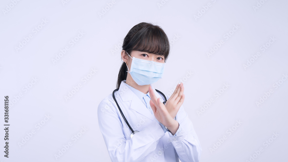 Young female doctor woman wearing mask, making stop sign gesture, saysignaling No isolated on white background, refusing virus disease, close up, blank. Young female doctor woman wearing mask, making stop sign gesture, saysignaling No isolated on white background, refusing virus disease, close up, blank.