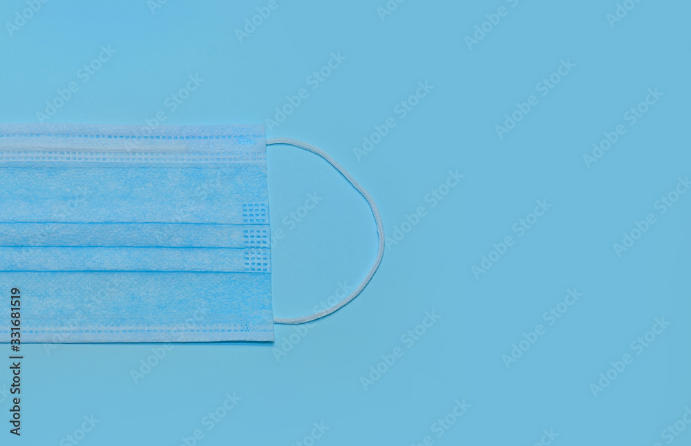 Medical surgical ear mask on a blue background Medical surgical ear mask on a blue background