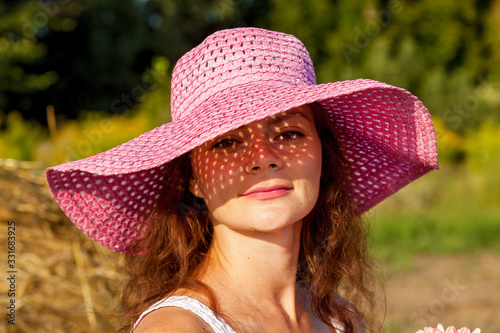 A beautiful woman in the pink hat