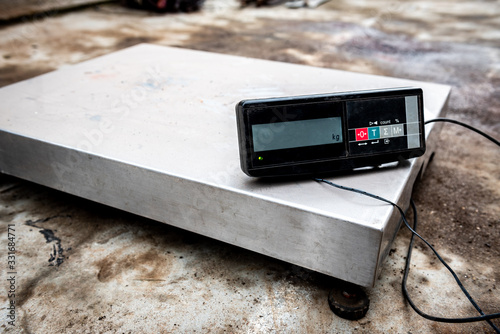 Warehouse digital platform scales on concrete background. photo