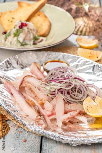Fish slices with onion, sauce and lemon