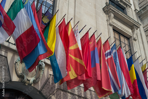 European flags on the facade of an old building © Hennadii