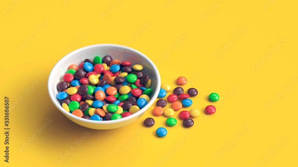 Colorful coated chocolate candies in white bowl isolated on yellow background