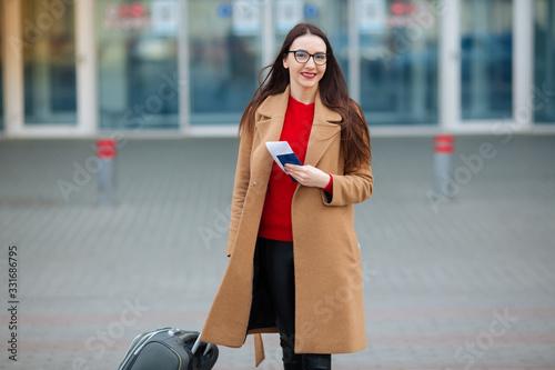 Young beautiful business woman suitcase in urban setting