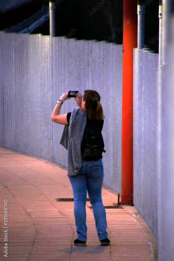 Woman taking a photography in the street