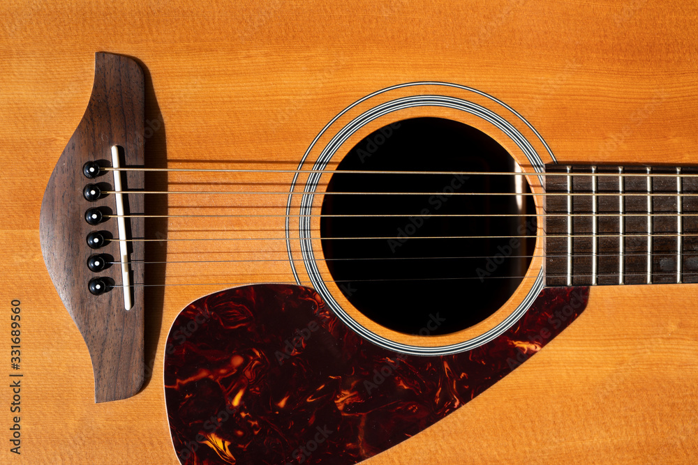 Fototapeta Wooden acoustic folk guitar detail