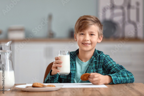 Little boy drinking milk an...