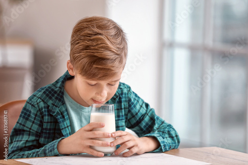 Little boy drinking milk in...