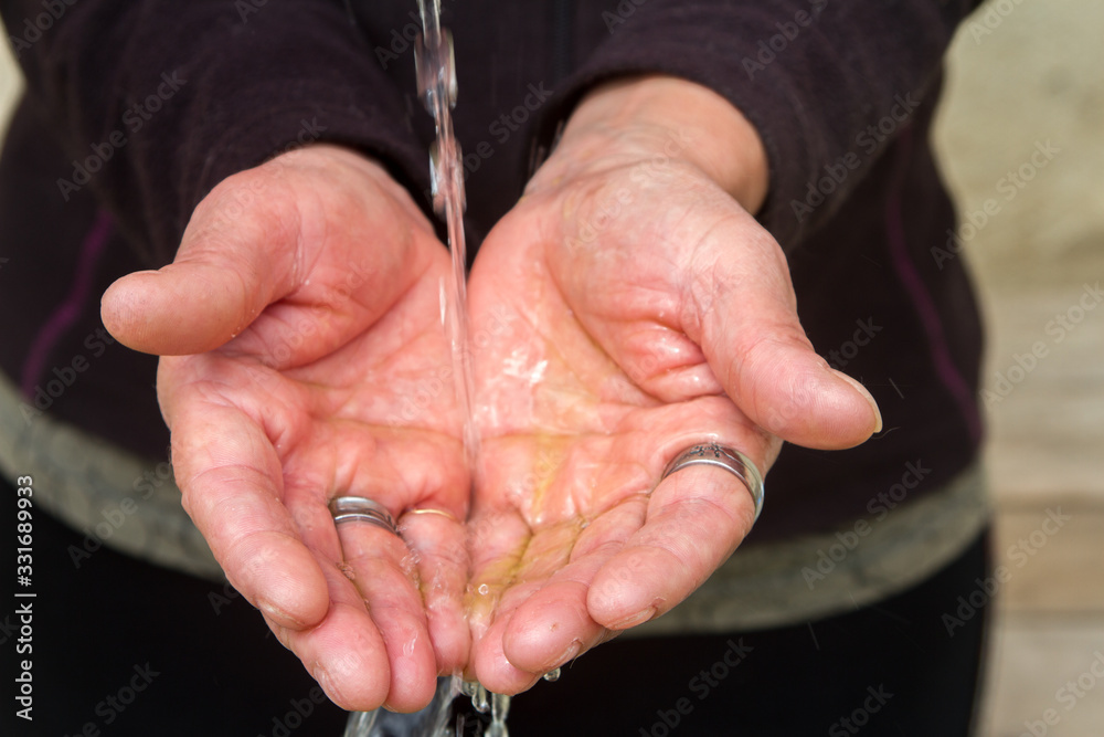 hands that are sprinkled with the hand gel disinfectant and then washed for prevention of viruses such as coronavirus or covid 19