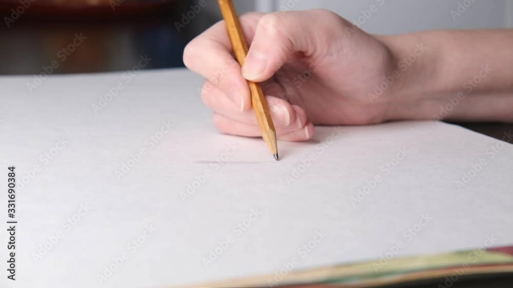 The artist at work draws. Close up. Side view.Selective soft focus. Blurred background The artist at work draws. Close up. Side view.Selective soft focus. Blurred background