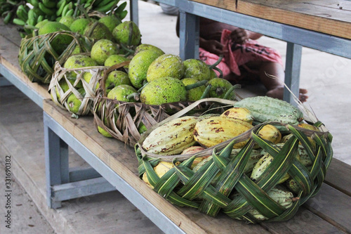 Samoan using coconut leaves to weave a basket for carrying the agricultural product. photo