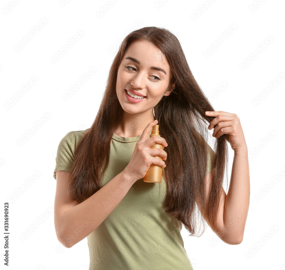 Beautiful young woman with hair spray on white background Beautiful young woman with hair spray on white background
