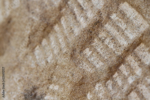 The background pattern on the diagonal cement floor.