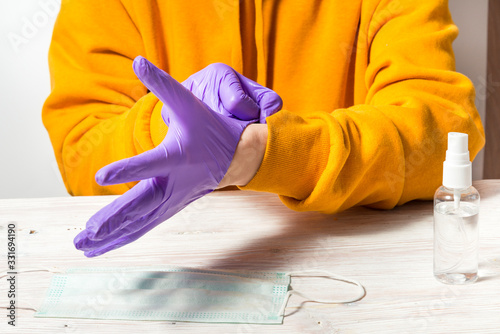 Teenager girl wearing latex gloves, coronavirus prevention