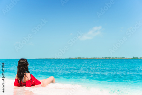 Young woman on a tropical beach with hat