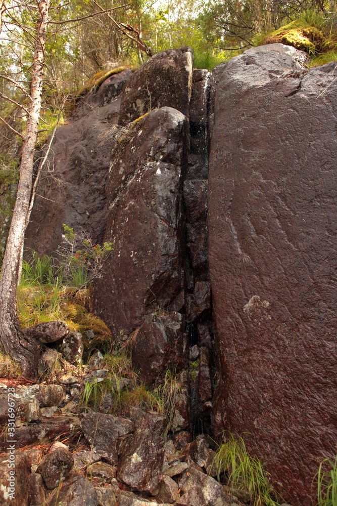 big fault or scratch on the rock. brown rock structure close up. Pile of big granite stones. Texture on the rock surface. Massive stone with scratches on the surface, monochromatic. big fault or scratch on the rock. brown rock structure close up. Pile of big granite stones. Texture on the rock surface. Massive stone with scratches on the surface, monochromatic.