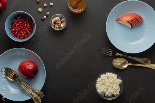 Blue breakfast dishes on dark concrete. Nuts, honey, fruits. Healthy Cooking