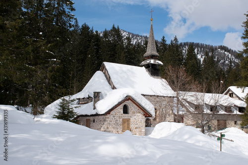 church with snow on the dolomites