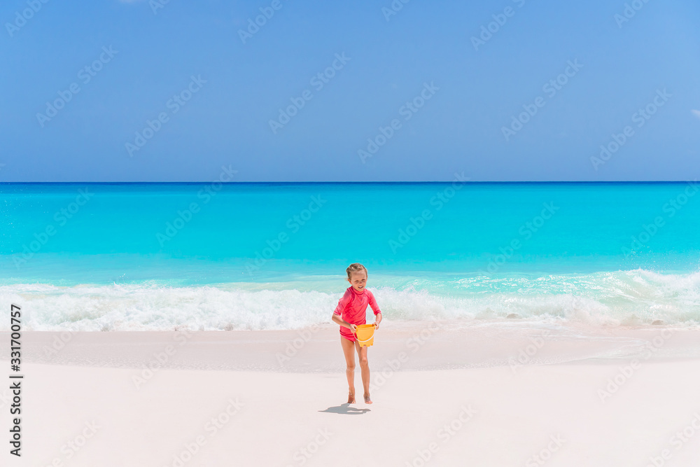 Portrait of adorable little girl at beach during summer vacation