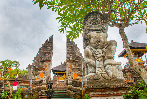 UBUD, BALI, INDONESIA - APRIL 2017: Beautiful Balinese entrance gate of the temple, a Pura Pusen temple in the center of Ubud, Bali, Indonesia.
