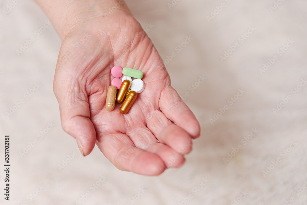 Many different pills in the hand of an elderly person. Many different pills in the hand of an elderly person.