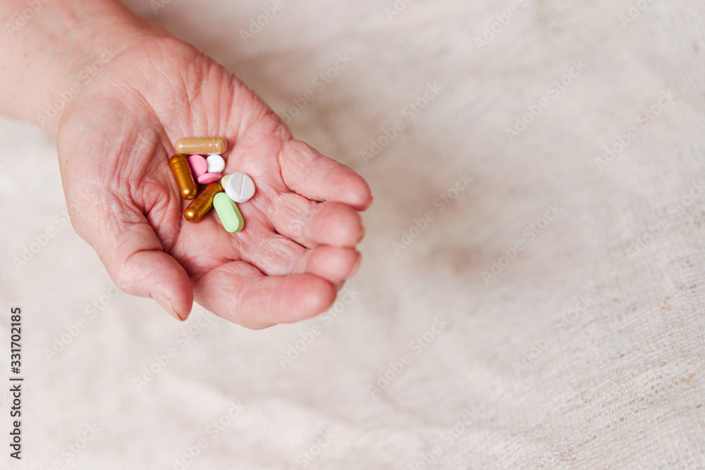 Many different pills in the hand of an elderly person. Many different pills in the hand of an elderly person.