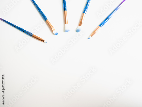 Classic blue eyeshadow brushes isolated on white background with space for copy space.