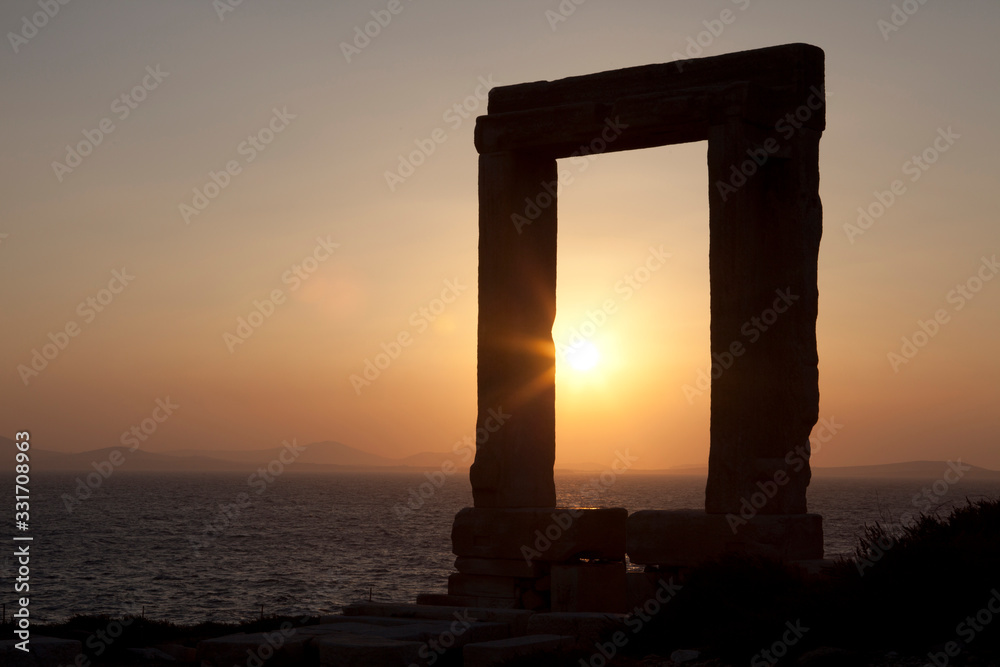 Naxos Town, Naxos / Greece - August 23, 2014: Gate of the temple of Apollo, Portara, Naxos Town, Naxos, Cyclades Islands, Greece