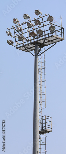 bright headlamps of an industrial plant of the stadium on a stee photo