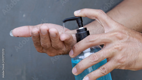 Female hands using wash hand sanitizer gel 