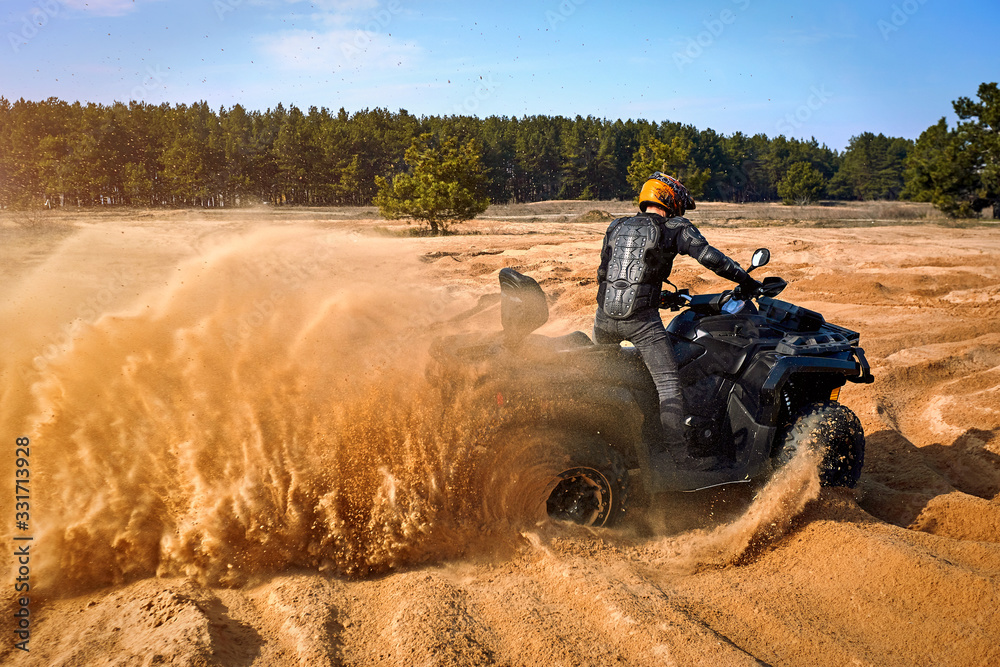 Racing in the sand on a four-wheel drive quad. Racing in the sand on a four-wheel drive quad.