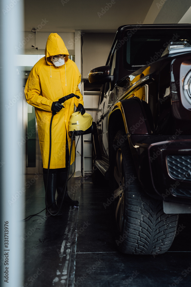 Man in protective suit disinfect a car after during the new coronavirus Covid-19. Man in protective suit disinfect a car after during the new coronavirus Covid-19.