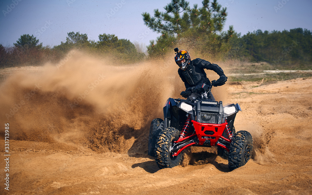Racing in the sand on a four-wheel drive quad. Racing in the sand on a four-wheel drive quad.