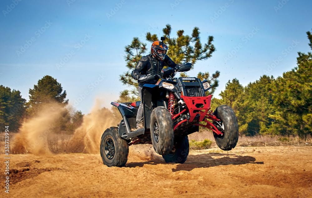 Racing in the sand on a four-wheel drive quad. Racing in the sand on a four-wheel drive quad.