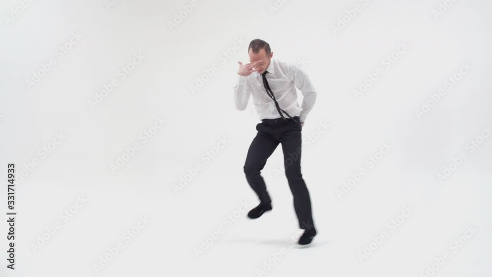 Happy office clerk dancing a break dance. A guy in a classic style dances the lower break and stands on his hand, looking at the camera in surprise. Dance from a computer game Happy office clerk dancing a break dance. A guy in a classic style dances the lower break and stands on his hand, looking at the camera in surprise. Dance from a computer game