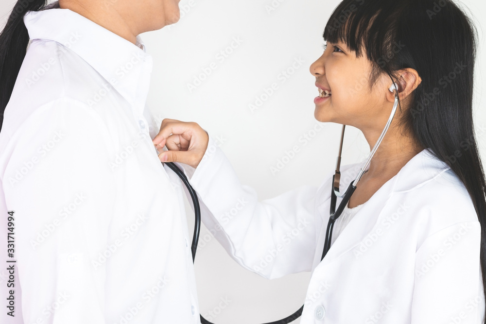 An Asian girl doctor wearing a white adhesive shirt is using a stethoscope. The doctor listens to the woman's respiratory system with a smiling face on a white background. An Asian girl doctor wearing a white adhesive shirt is using a stethoscope. The doctor listens to the woman's respiratory system with a smiling face on a white background.