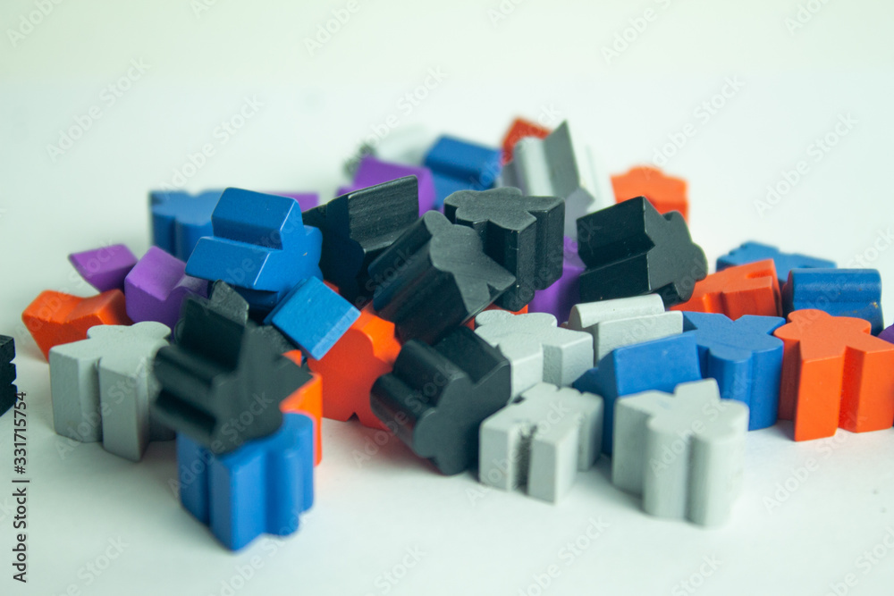Stacked meeples prepared for a game of board game. Army of meeples colored wooden figures with human shape. Stacked meeples prepared for a game of board game. Army of meeples colored wooden figures with human shape.
