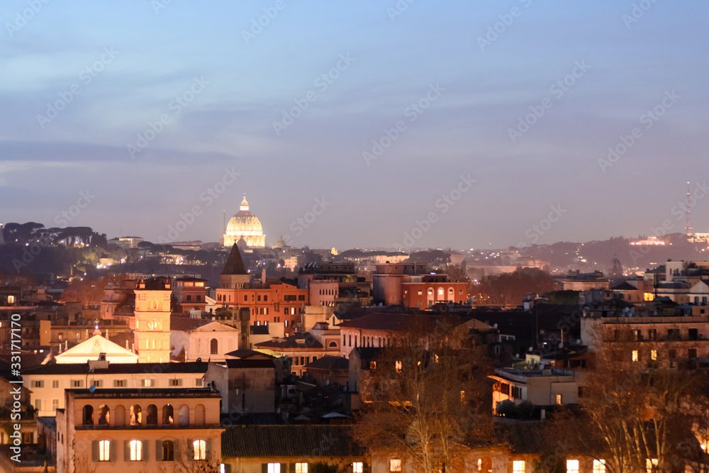 Night longexposure shot of the magnificent city of Rome seen at sunset time from a garden on the hills, some famous monuments are visible 