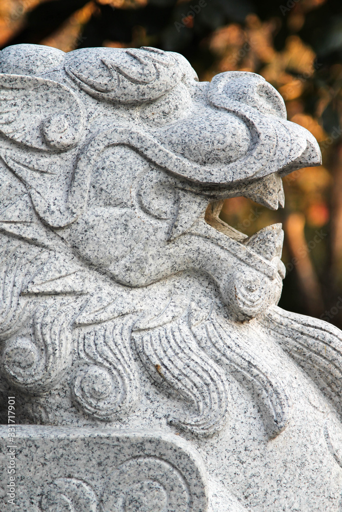 Large guardian lion carved from marble in the Royal Park Rajapruek, Chiangmai, Northern Thailand.