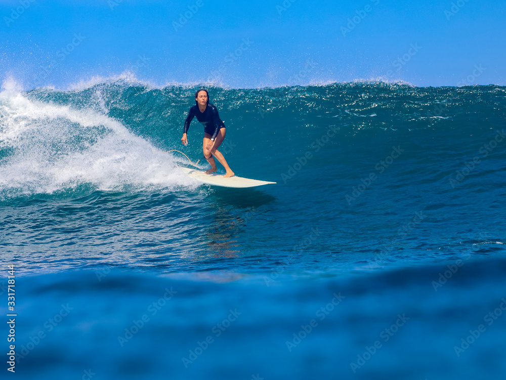 Female surfer on a wave