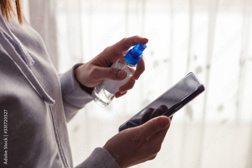 Fototapeta premium Precautions regarding coronavirus, cell phone disinfection