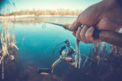 Fishing with rod on lake. man's hand with spinning
